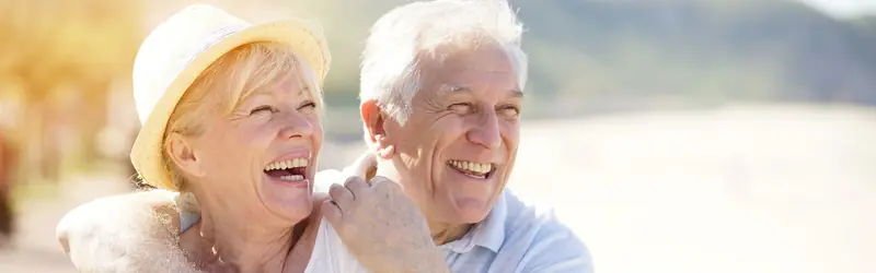 An older couple embracing on a sunny day