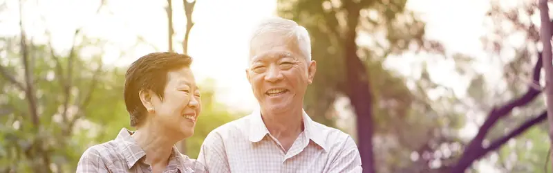 A group of older adults laughing together outdoors