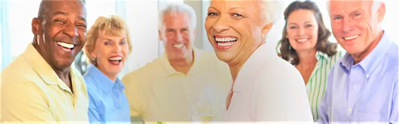 A group of older friends smiling together outdoors